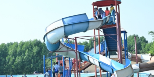 a group of people enjoying water slides at Camp United