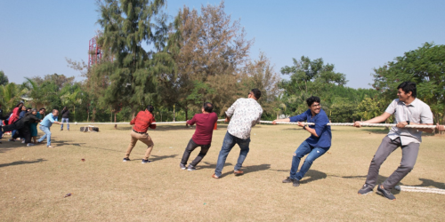 Group of people playing tug of war-camp unity